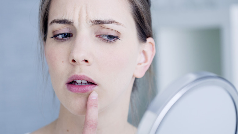 woman looking at wrinkles