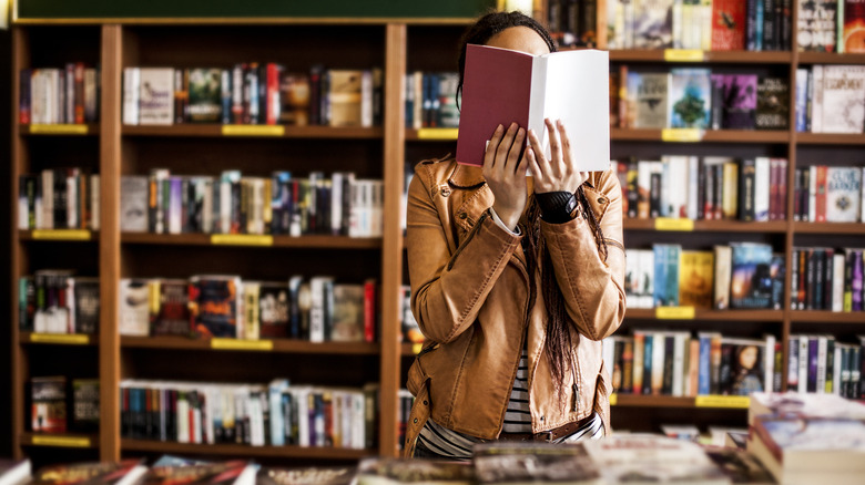 Woman reads a book in a bookstore