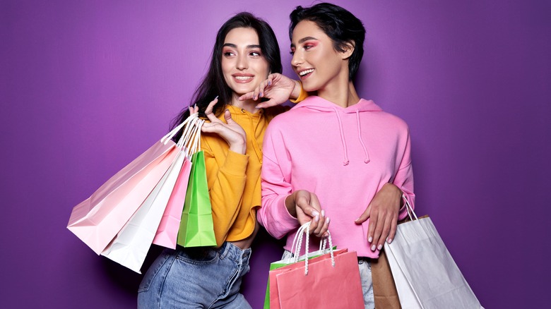 Woman wearing makeup hold shopping bags