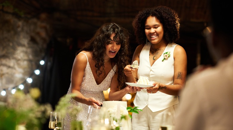 Married couple cutting cake