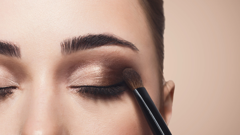 Woman applying eyeshadow