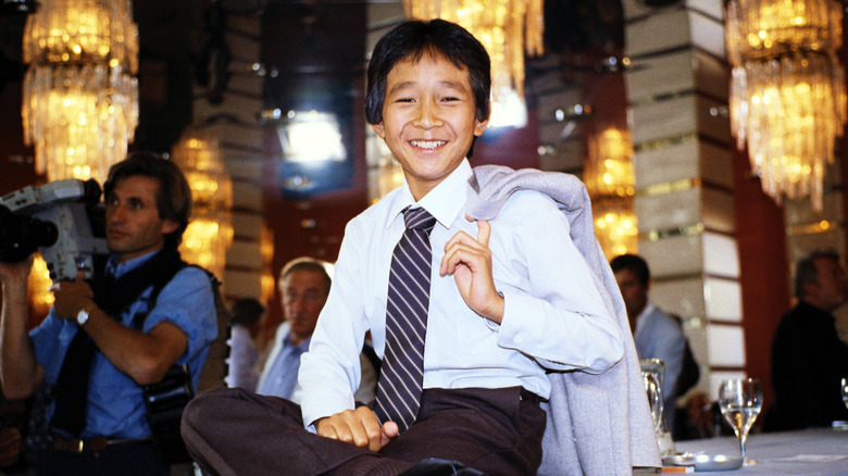 Ke Huy Quan posing for a photo in 1984