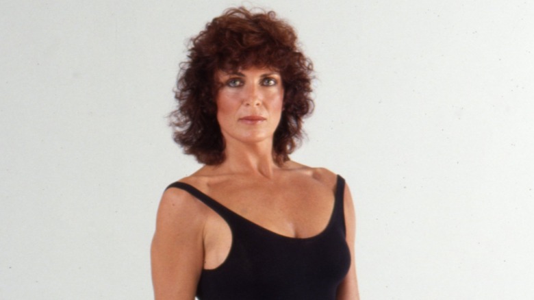 A portrait of Joanna Cassidy, wearing a black leotard in front of a white background, circa 1985