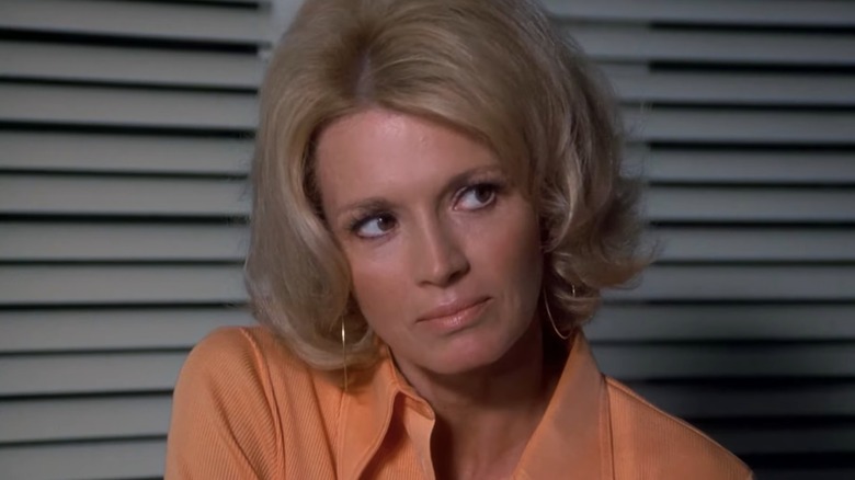 A close-up of Pepper Anderson in front of Venetian blinds in an episode of Police Woman.