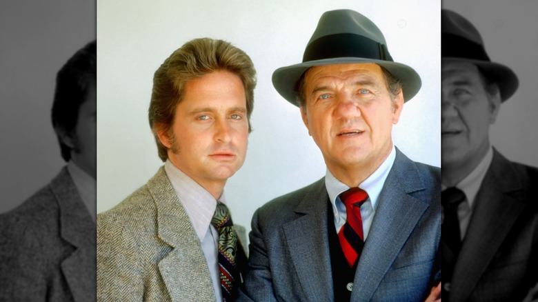 A portrait of Michael Douglas and Karl Malden in suits on the set of The Streets of San Francisco.