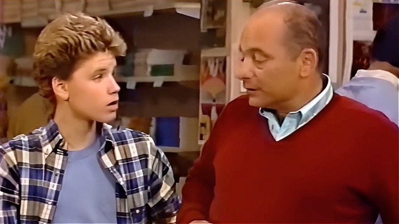 Roomies cast Burt Young and Corey Haim in scene at bookstore