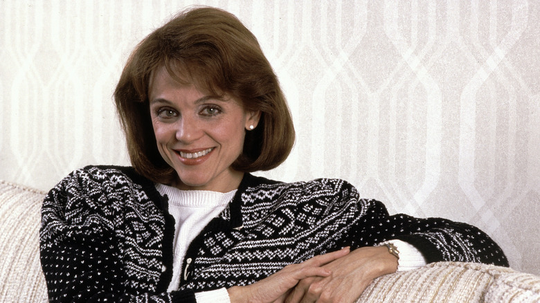 Valerie Harper posing on sofa smiling