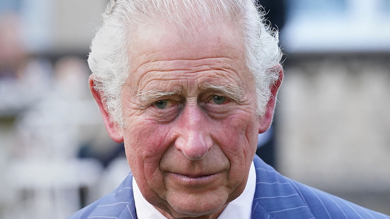 King Charles III frowning