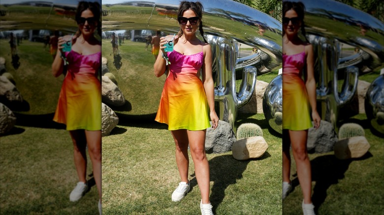 Katie Thurston holding a beverage at Coachella