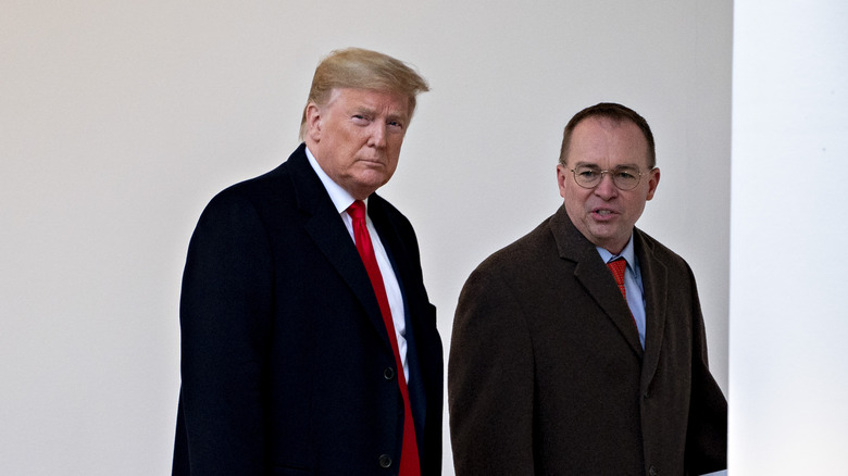 Mick Mulvaney and Donald Trump walking 