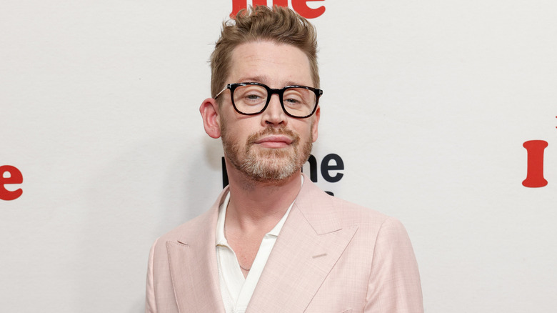 Macaulay Culkin wearing black glasses