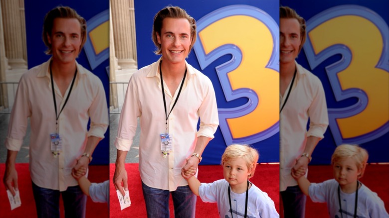 Erik Von Detten holding a little boy's hand