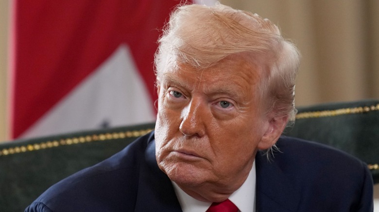 Donald Trump listens as he meets Keir Starmer at Trump Turnberry golf club in Scotland (2025)