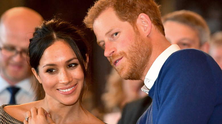Meghan Markle and Prince Harry confer about something