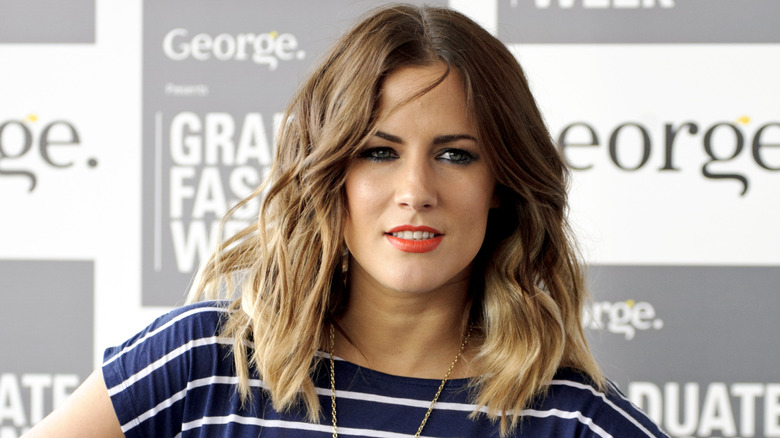 Caroline Flack posing at event