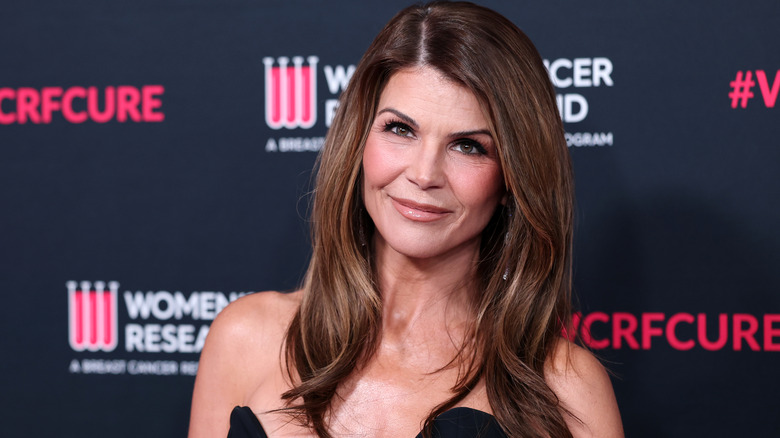 Lori Loughlin smiling at red carpet event