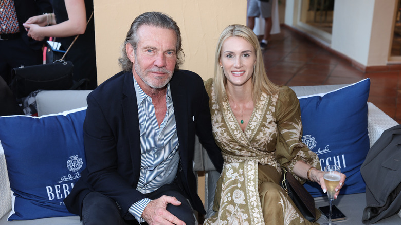 Dennis Quaid and Laura Savoie sitting together at an event in 2023