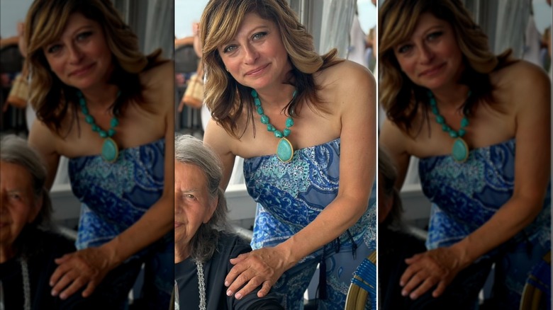 Maria Bartiromo bent over in a blue jumpsuit.