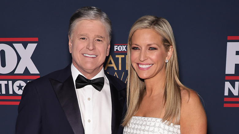 Sean Hannity and Ainsley Earhardt smiling at a Fox event