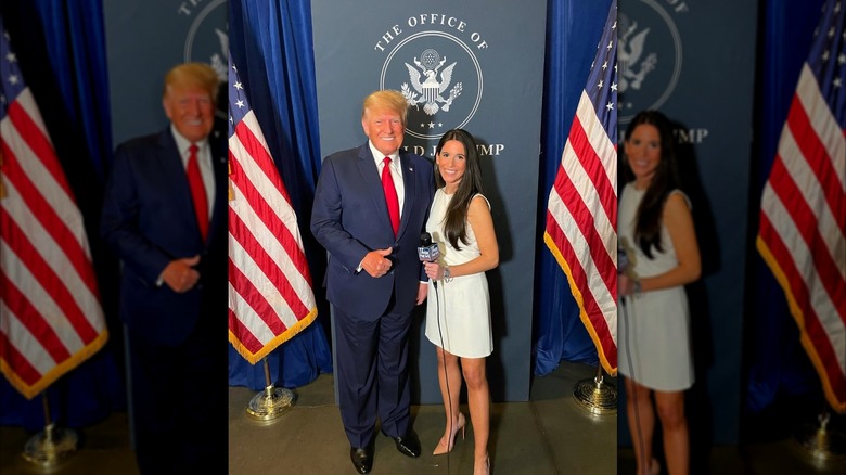Brooke Singman holding a microphone and wearing a white dress while posing next to Donald Trump.