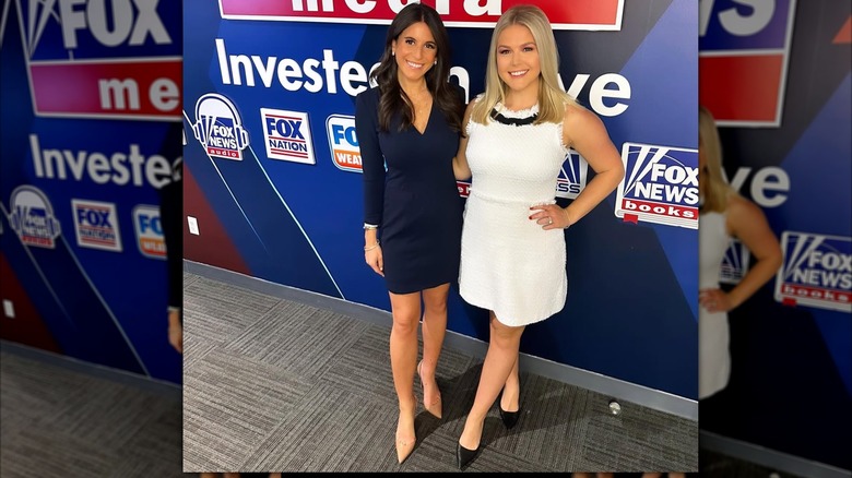 Brooke Singman wearing a short blue dress smiling next to Karoline Leavitt who's wearing a white gown.