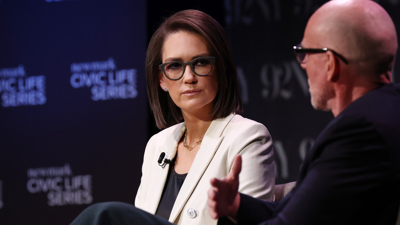 Jessica Tarlov listening intently during a panel talk on stage
