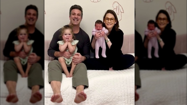 Brian McKenna and Jessica Tarlov smiling with their two children