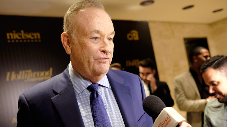 Bill O'Reilly speaking into mic at event