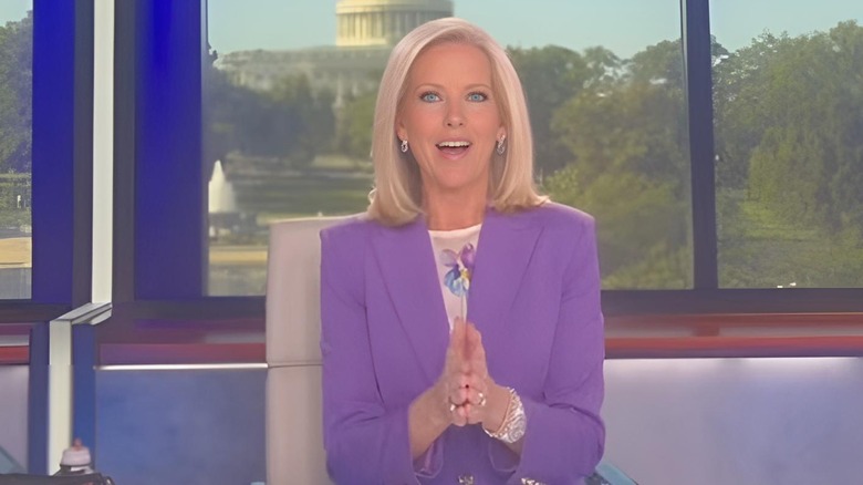 Shannon Bream with an orange fake tan sitting at her Fox News hosting desk
