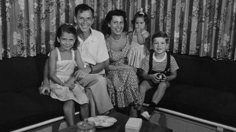 The entire Sinatra family of five sitting together in a black and white photo when Tina Sinatra was a child.