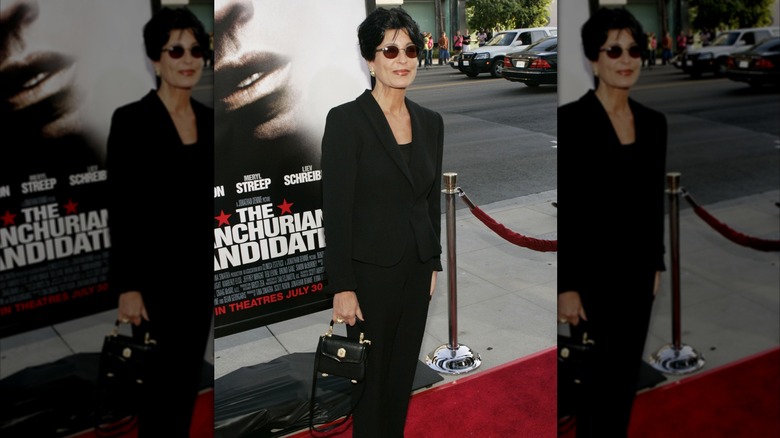Tina Sinatra walking the red carpet and wearing sunglasses at a premiere event for The Manchurian Candidate.