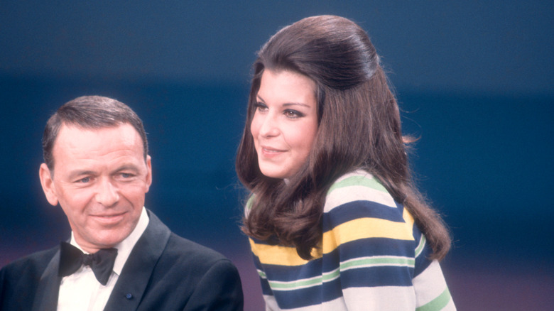 Frank Sinatra sitting with Tina Sinatra.