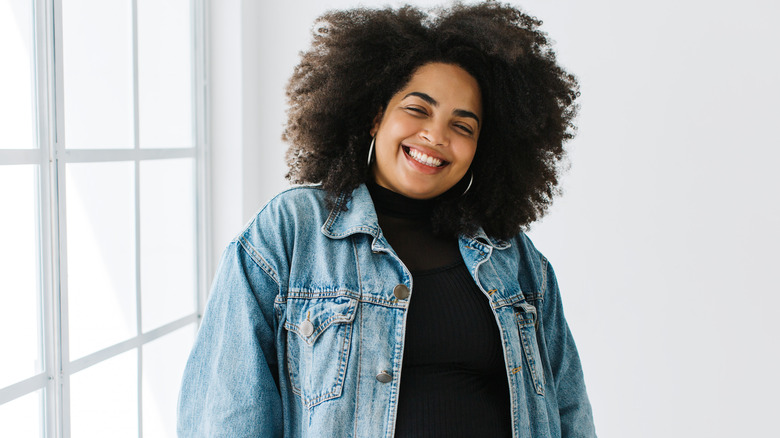 Woman smiling in a denim jacket