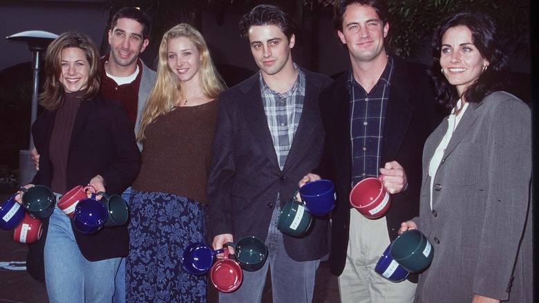 The cast of Friends smiling for a promotional photo in the 1990s