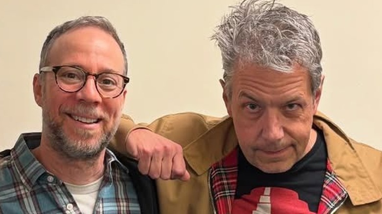 John Ross Bowie resting his arm on Kevin Sussman's shoulder.
