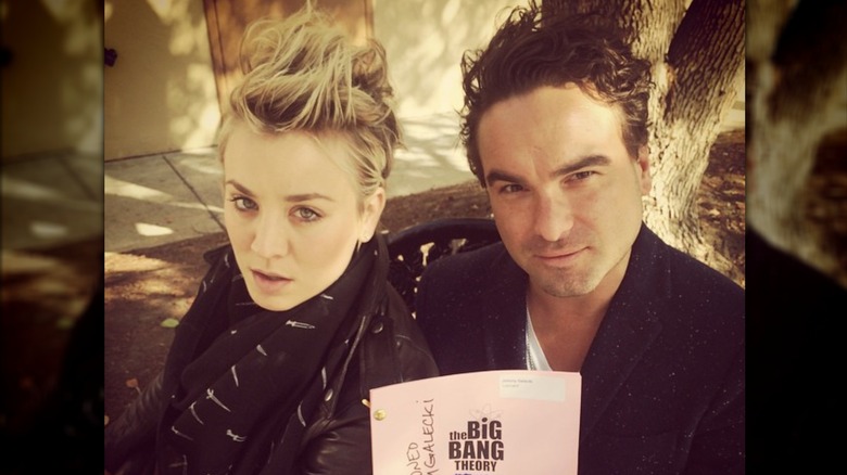 Kaley  Cuoco and Johnny Galecki posing with a "The Big Bang Theory" script.