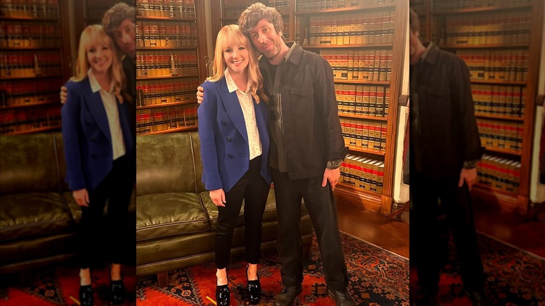 Simon Helberg posing with his arm around Melissa Rauch on the "Night Court" set.