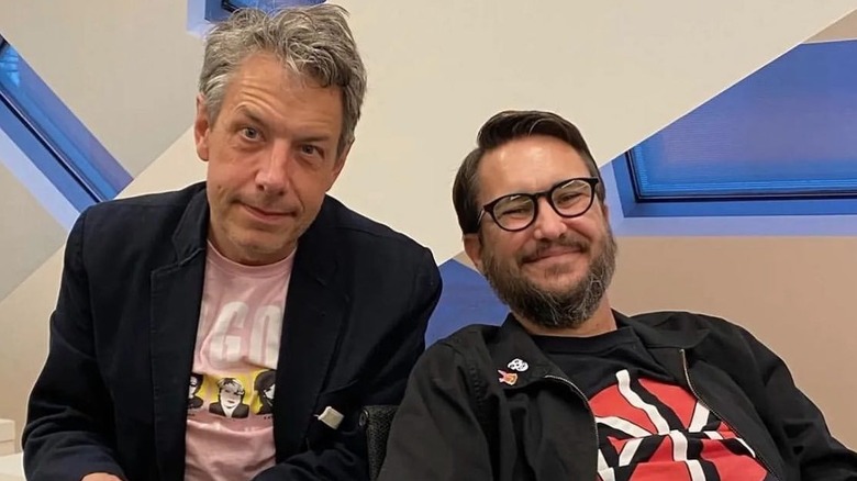 Wil Wheaton leaning back and smiling next to John Ross Bowie.
