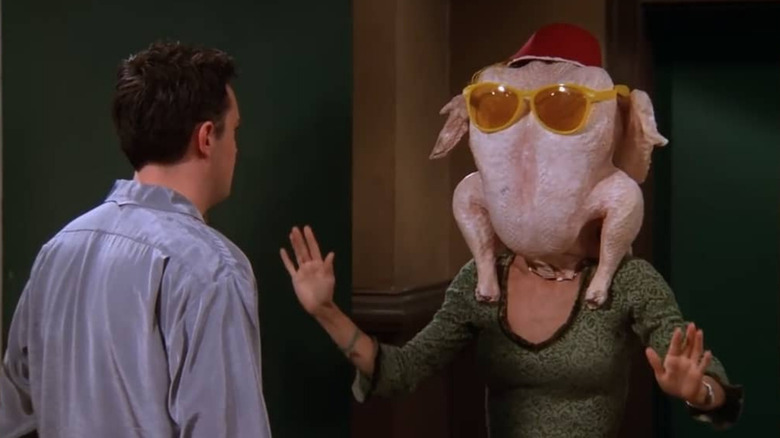 monica with a thanksgiving turkey on her head in friends