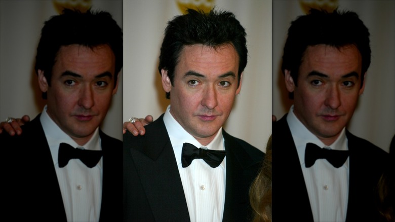 John Cusack in a tuxedo on a red carpet
