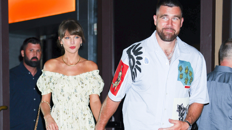 Taylor Swift and Travis Kelce holding hands