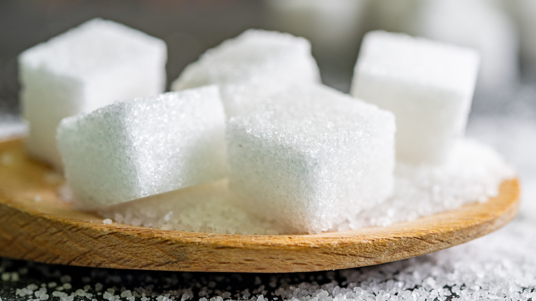 Sugar cubes on wooden surface