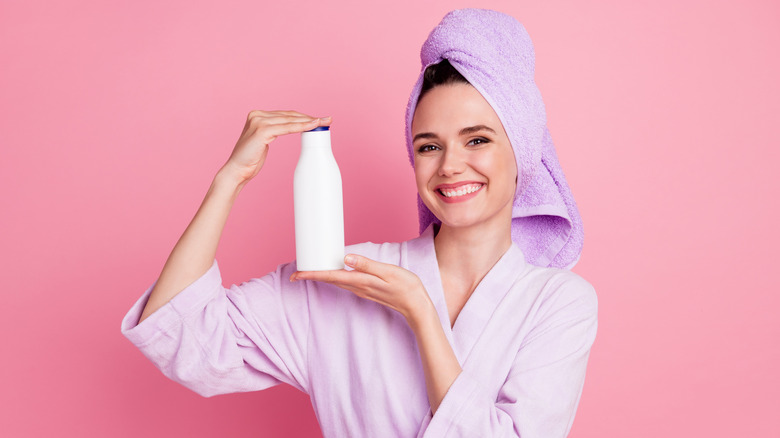 woman holding shampoo