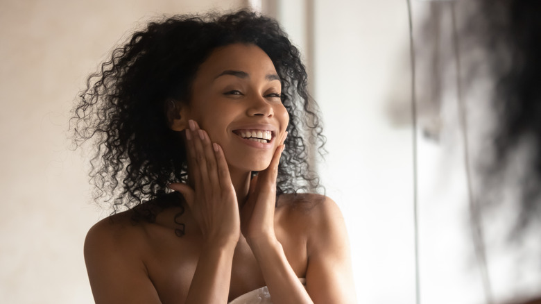 Woman applying treatment on face