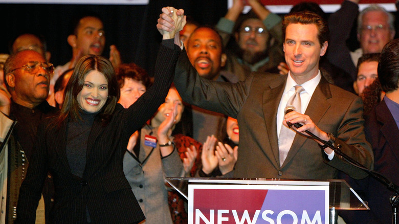 Gavin Newsom and Kimberly Guilfoyle holding hands
