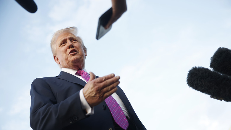 Donald Trump, swarmed by press.