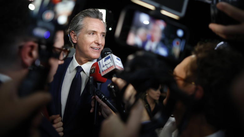 Gavin Newsom, swarmed by press.