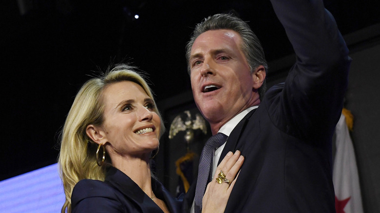 Democratic gubernatorial candidate Gavin Newsom and his wife Jennifer Siebel Newsom wave to supporters during election night event on November 6, 2018 in Los Angeles, California (2018)