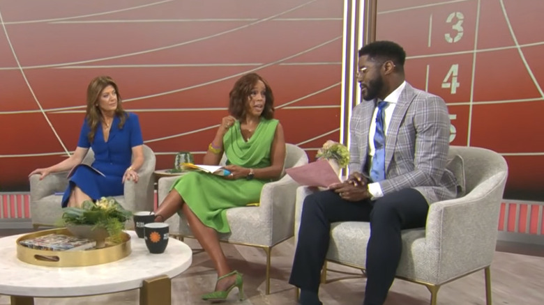 Gayle King sitting down between Norah O'Donnell and Nate Burleson