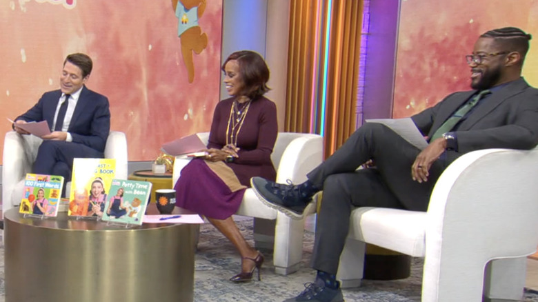 Tony Dokoupil, Gayle King, and Nate Burleson smiling